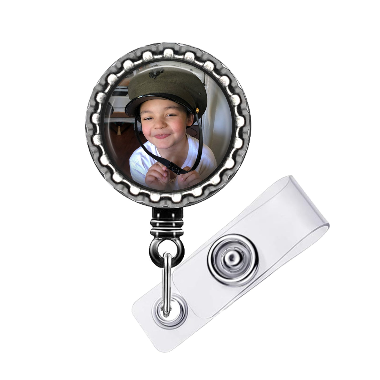 A child wearing a helmet is visible through a circular frame attached to a badge holder.