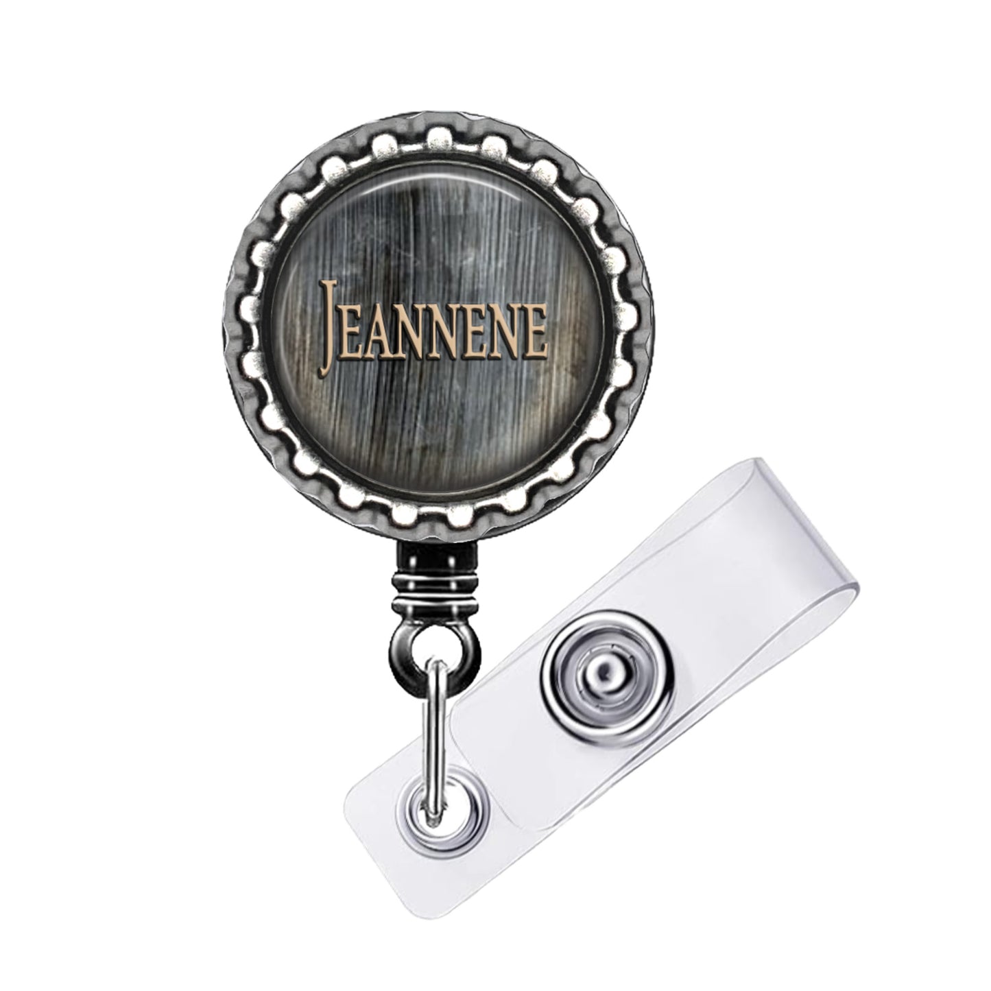 A metal badge with the name 'Jeanne' engraved on it, attached to a clear plastic holder.