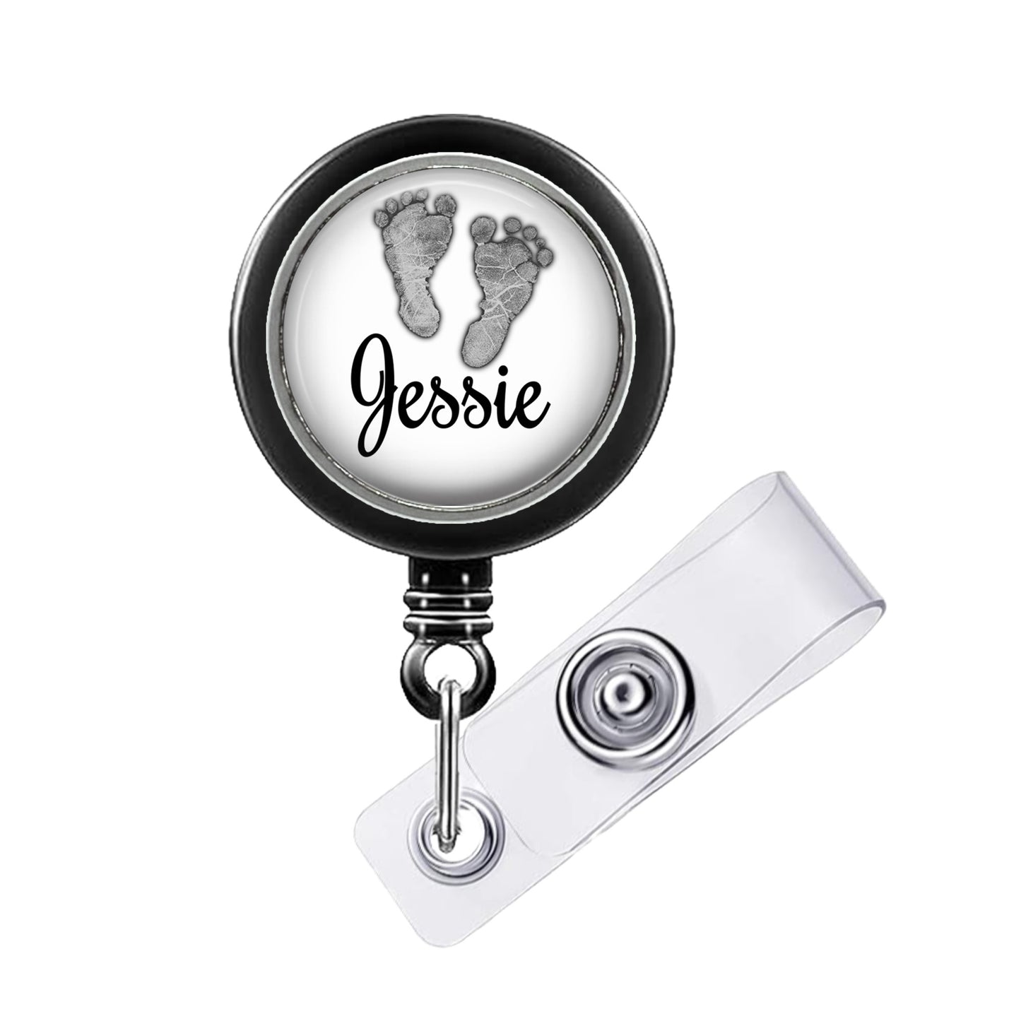 A black and white badge holder with a circular design featuring a pair of baby feet and the name " Jessie" written on it.