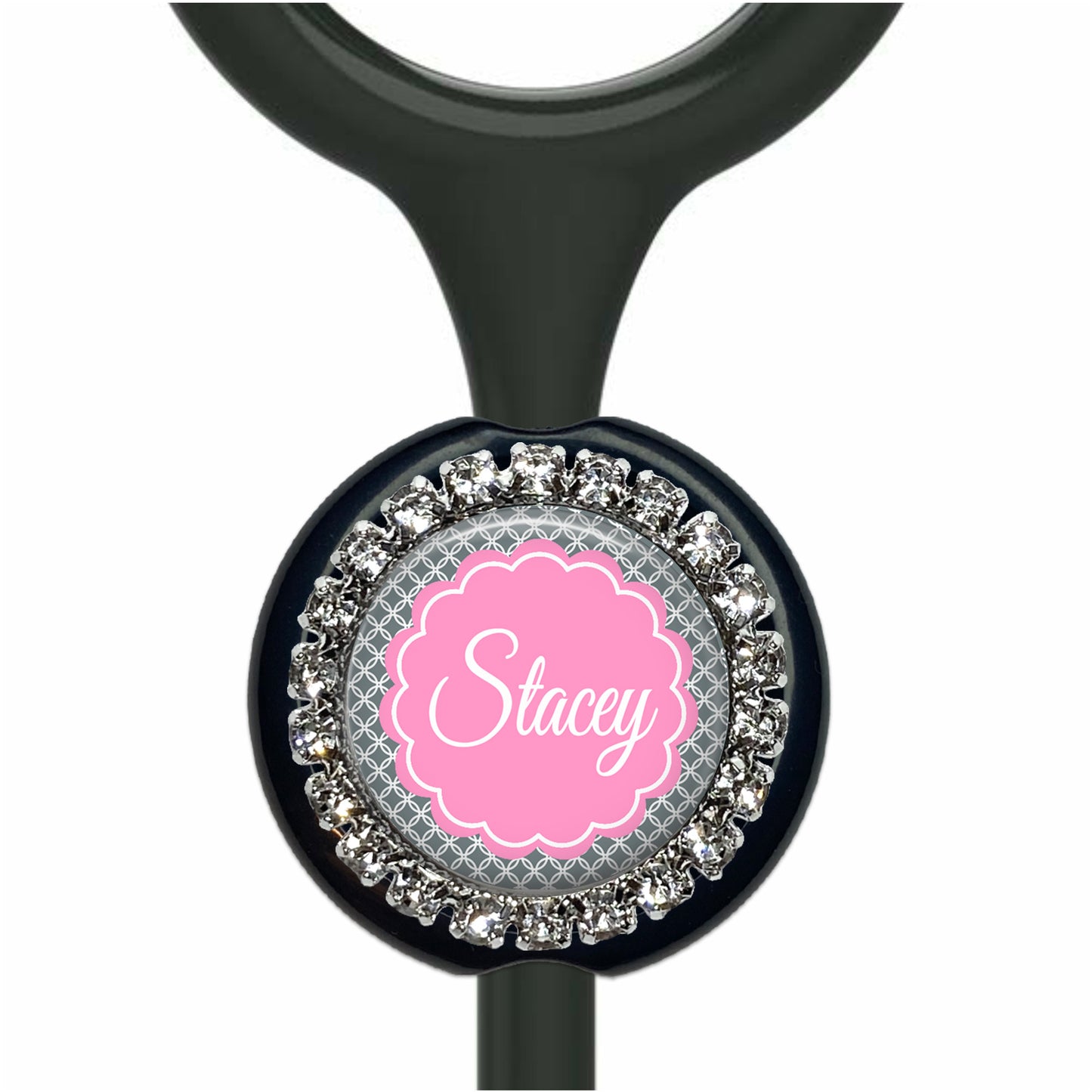 A black stethoscope with a personalized name badge attached to it.
