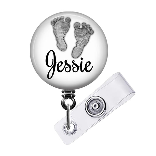 a badge with a picture of a baby's feet