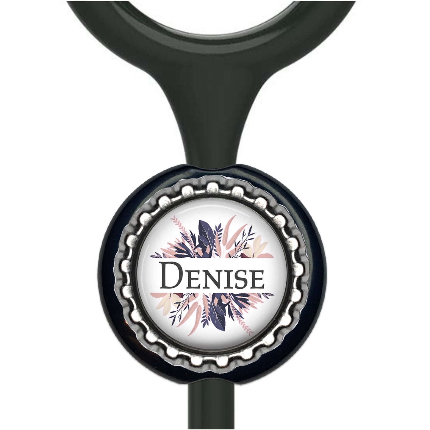 A black stethoscope with a round metal cap featuring a floral design and the name "Denise" written on it.