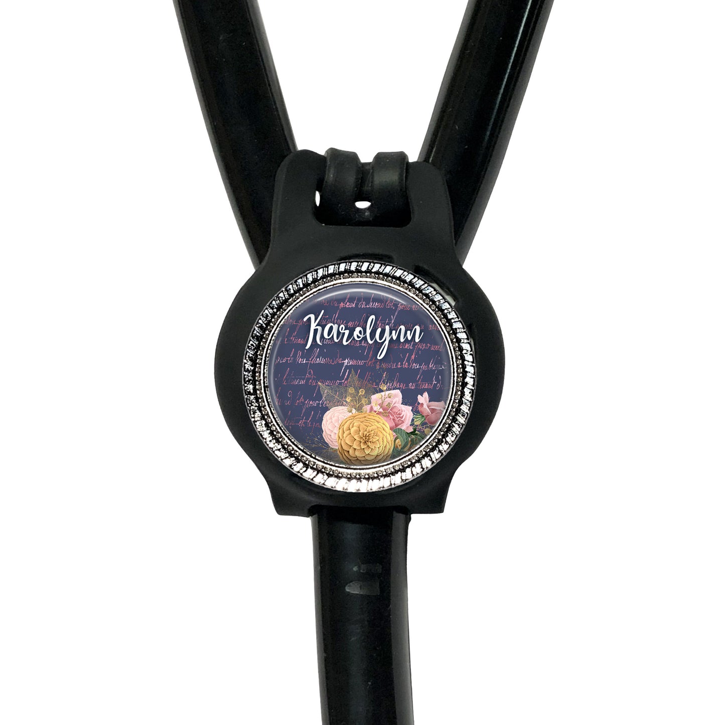 A black stethoscope with a round, personalized name badge attached to it.