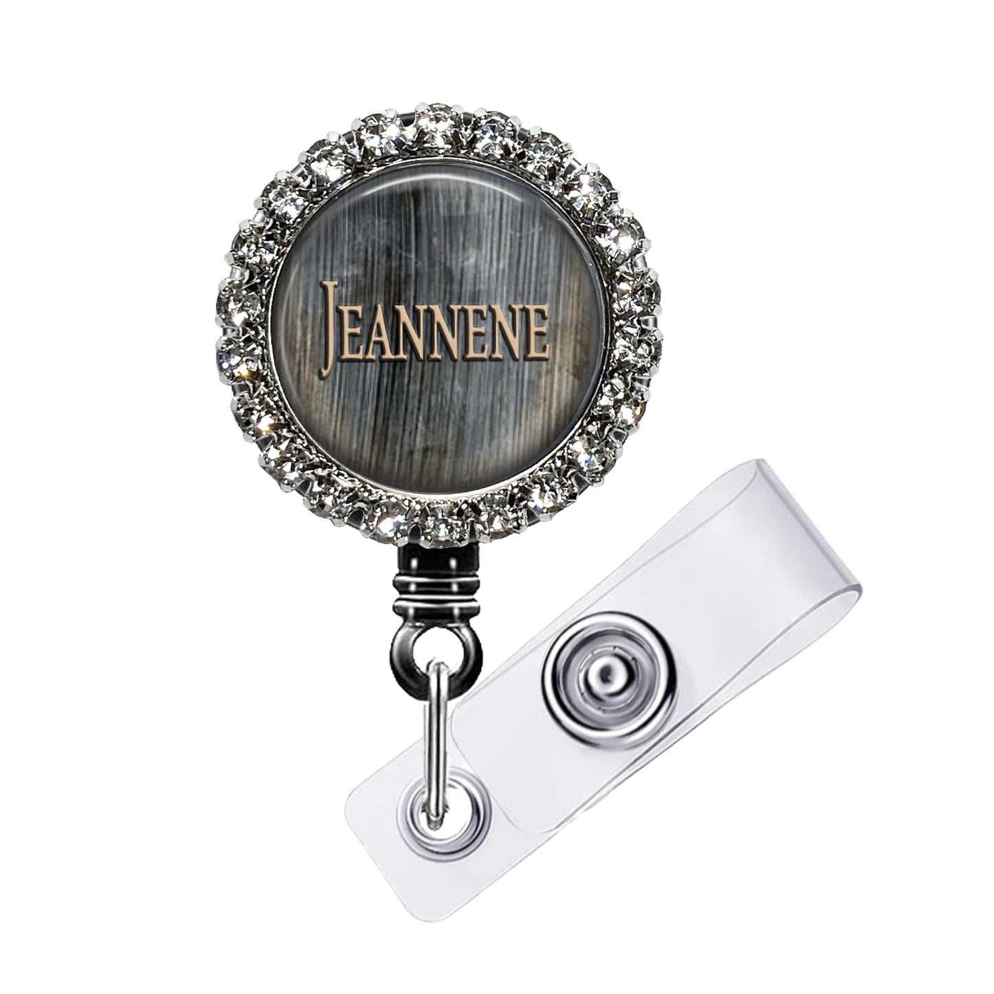 A personalized name badge with a silver and black design, featuring a name engraved on it. The name badge is adorned with a sparkling crystal or rhinestone embellishment.