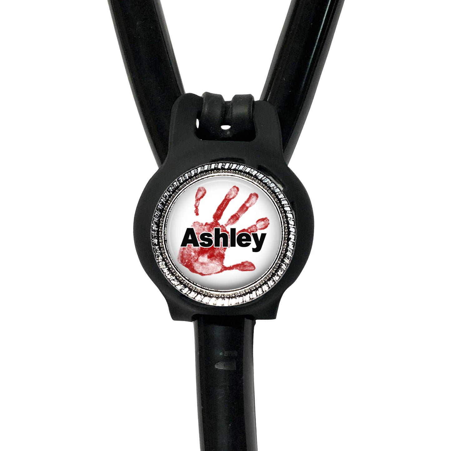 A black stethoscope with a personalized nameplate attached to it. The nameplate features a red handprint and the name "Ashley".