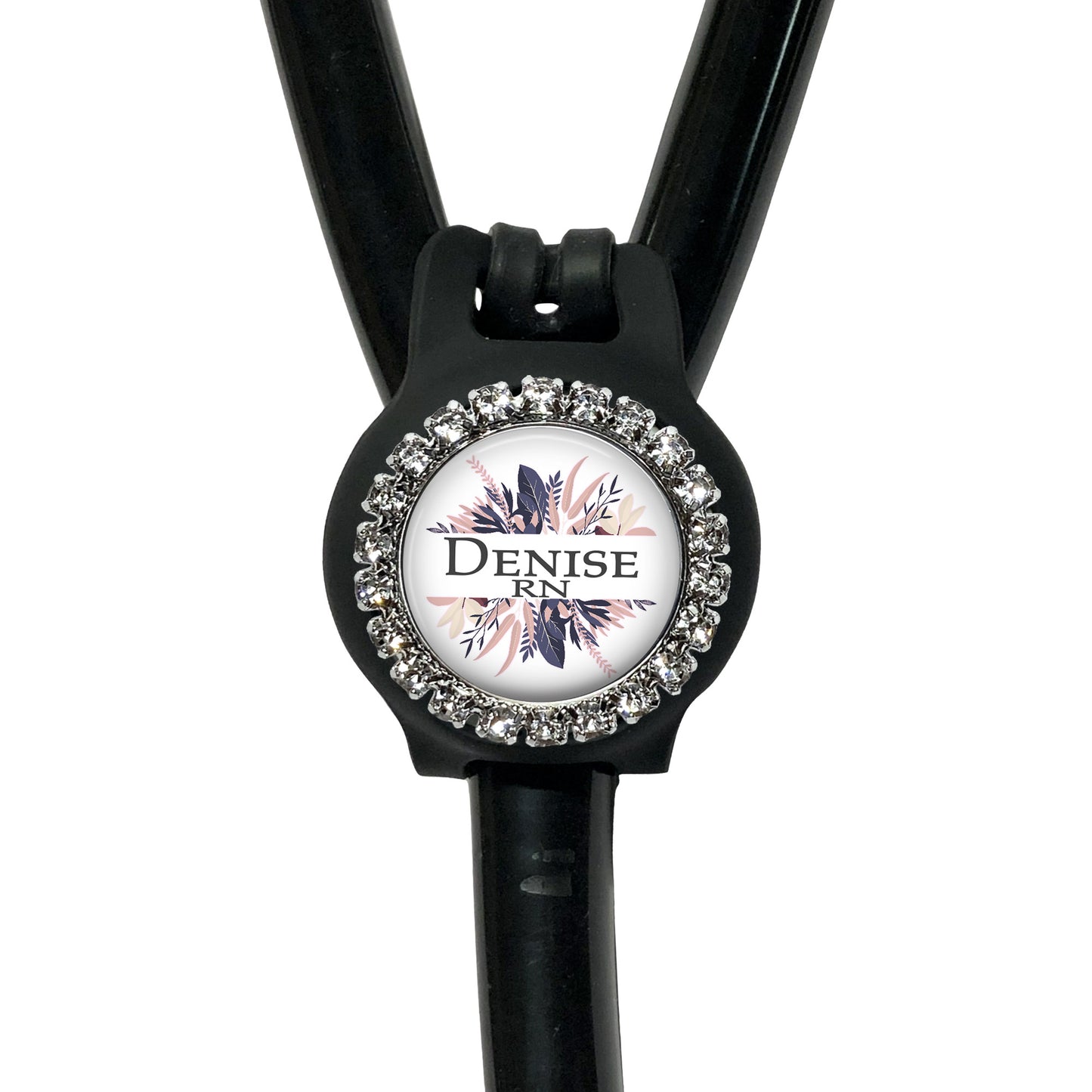 A black stethoscope with a decorative rhinestone-encrusted circular badge featuring the text "Denise RN" on it.