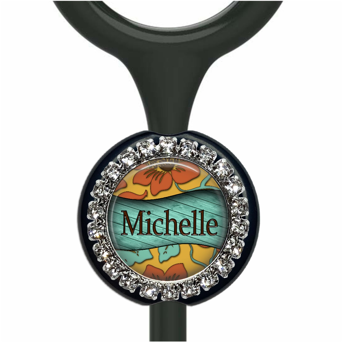 A personalized nameplate with a floral design and rhinestones around the edge.