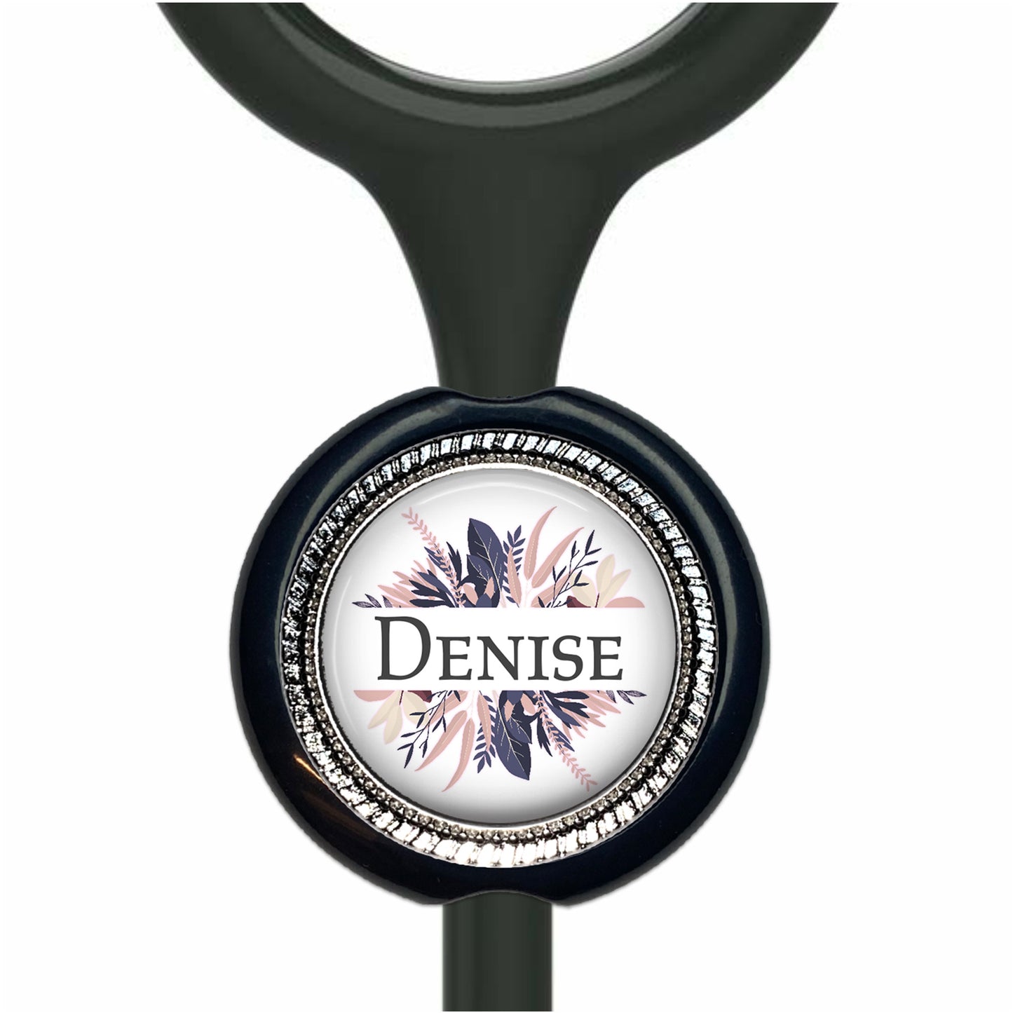 A black stethoscope with a round, decorative charm featuring a floral design and the name "Denise" written on it.
