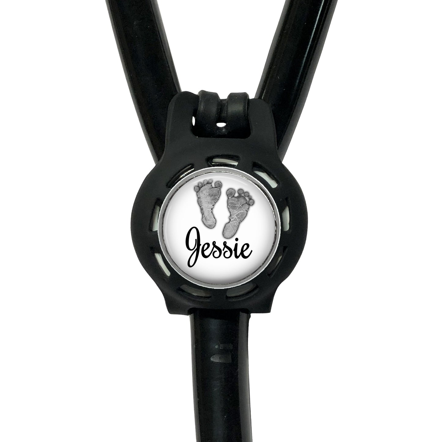 A black stethoscope with a personalized name badge attached to it.