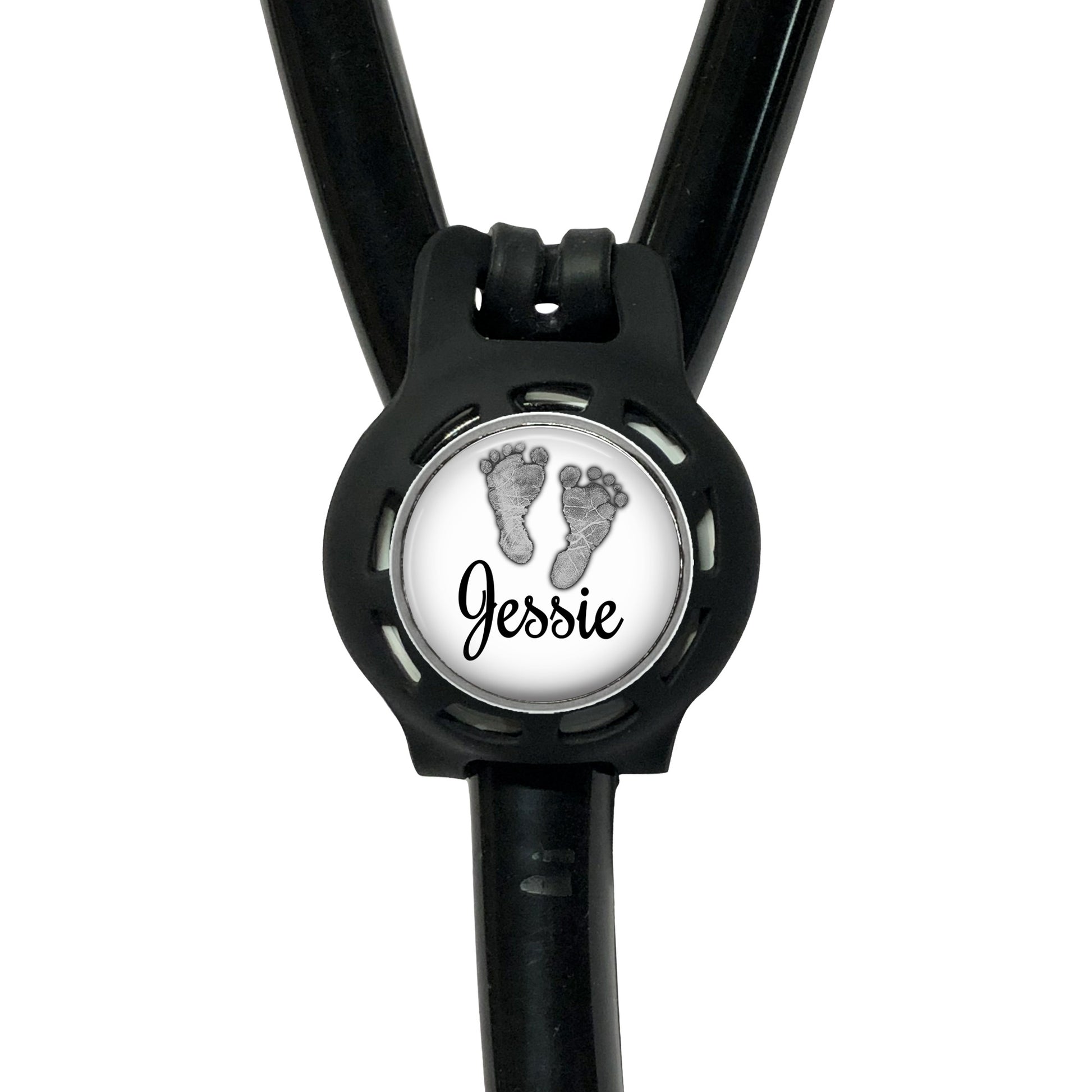A black stethoscope with a personalized name badge attached to it.