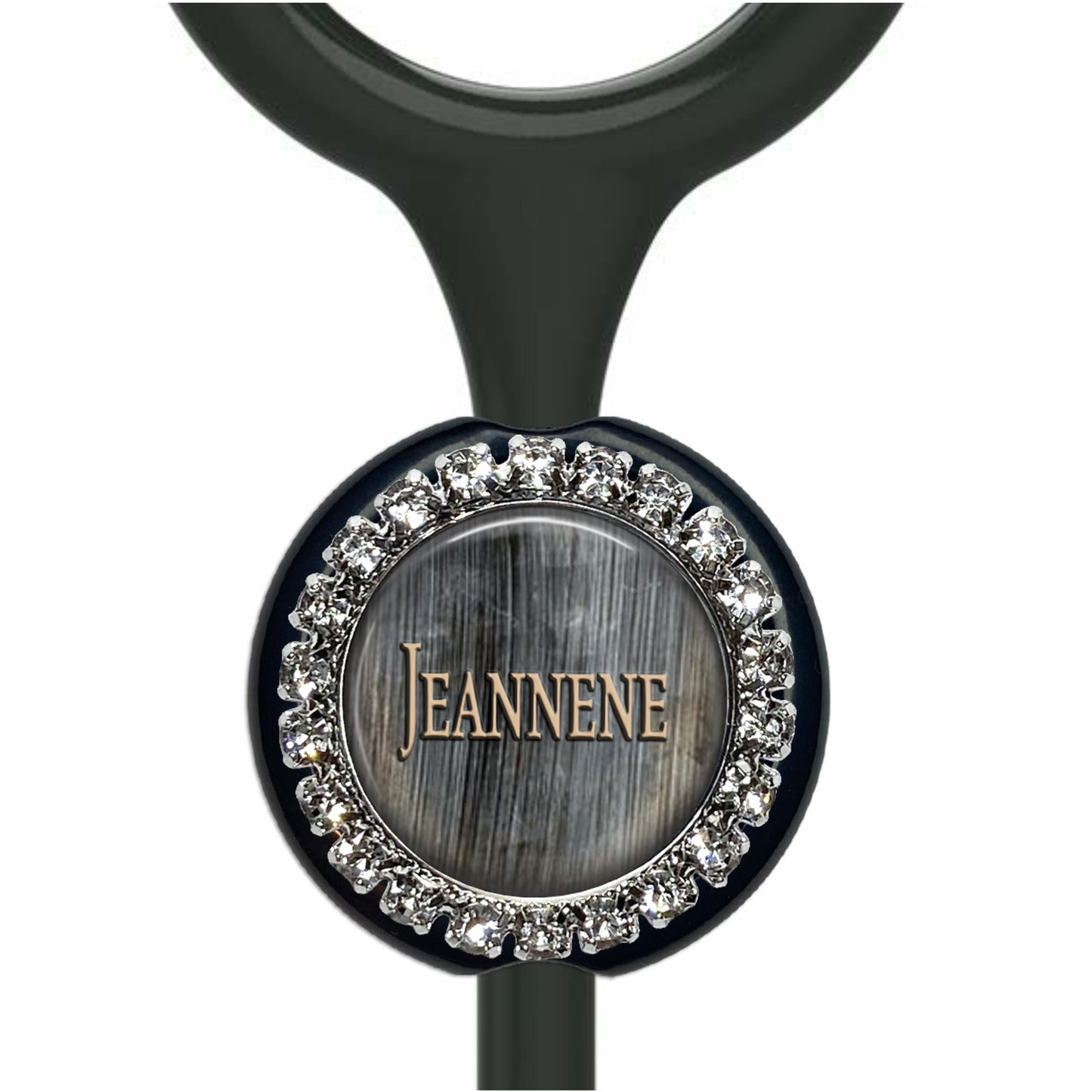 A personalized nameplate with a silver and black design, featuring a central circular element with the name "Jeanne" written on it, surrounded by a decorative border of small rhinestones or crystals.