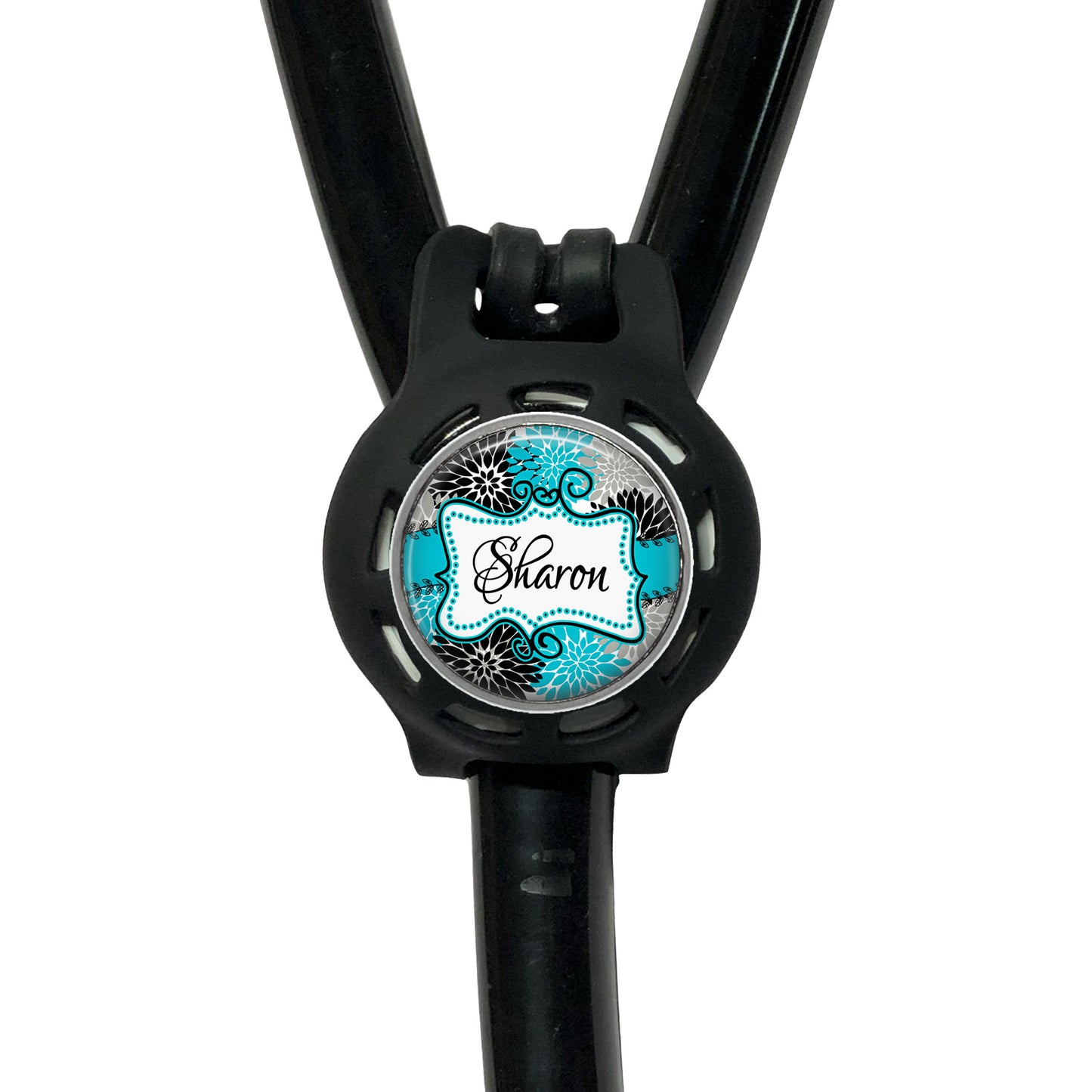 A black stethoscope with a round, personalized name badge attached to it.