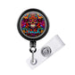 A colorful lanyard with a circular design featuring a skull and floral patterns.