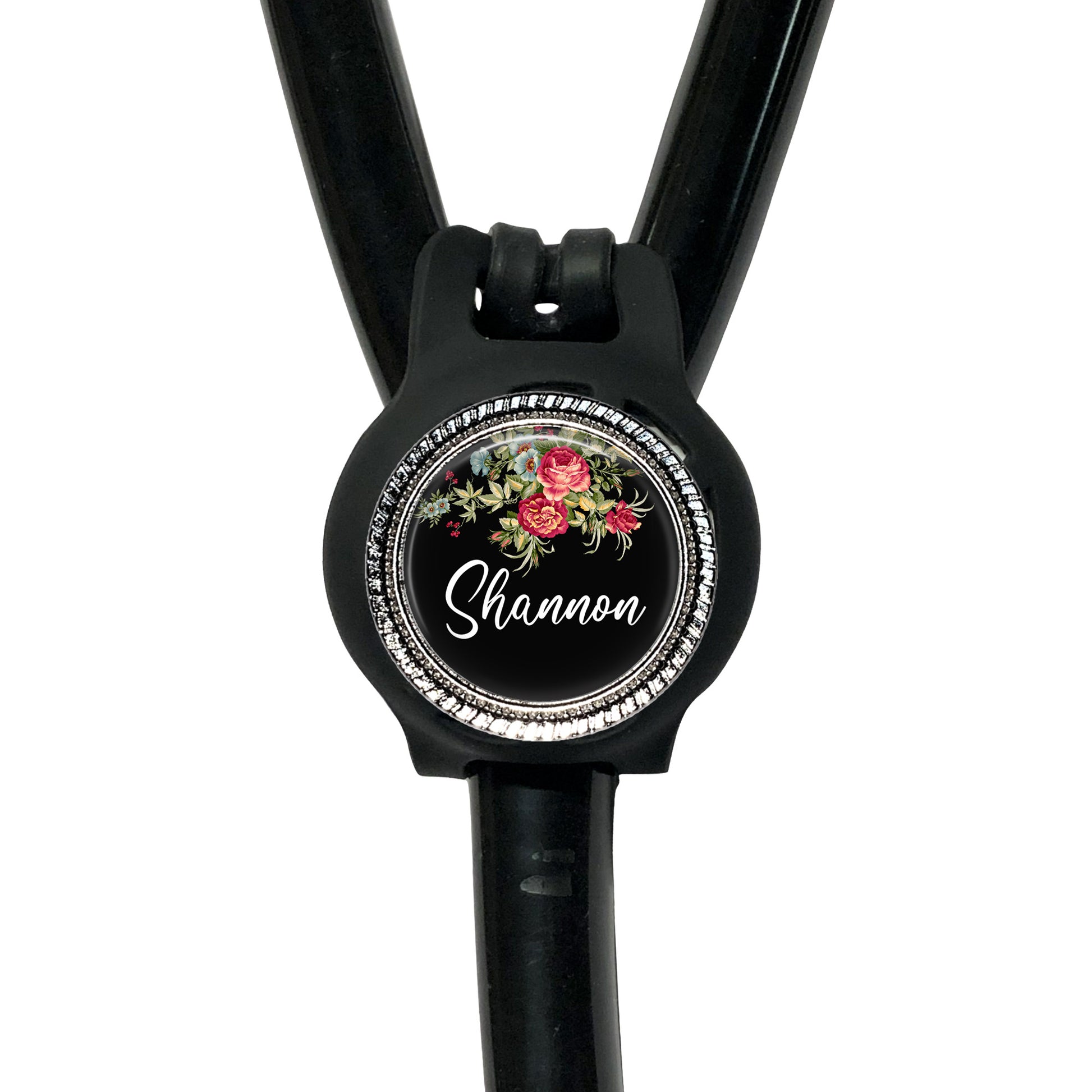 A black stethoscope with a personalized name badge attached to it.