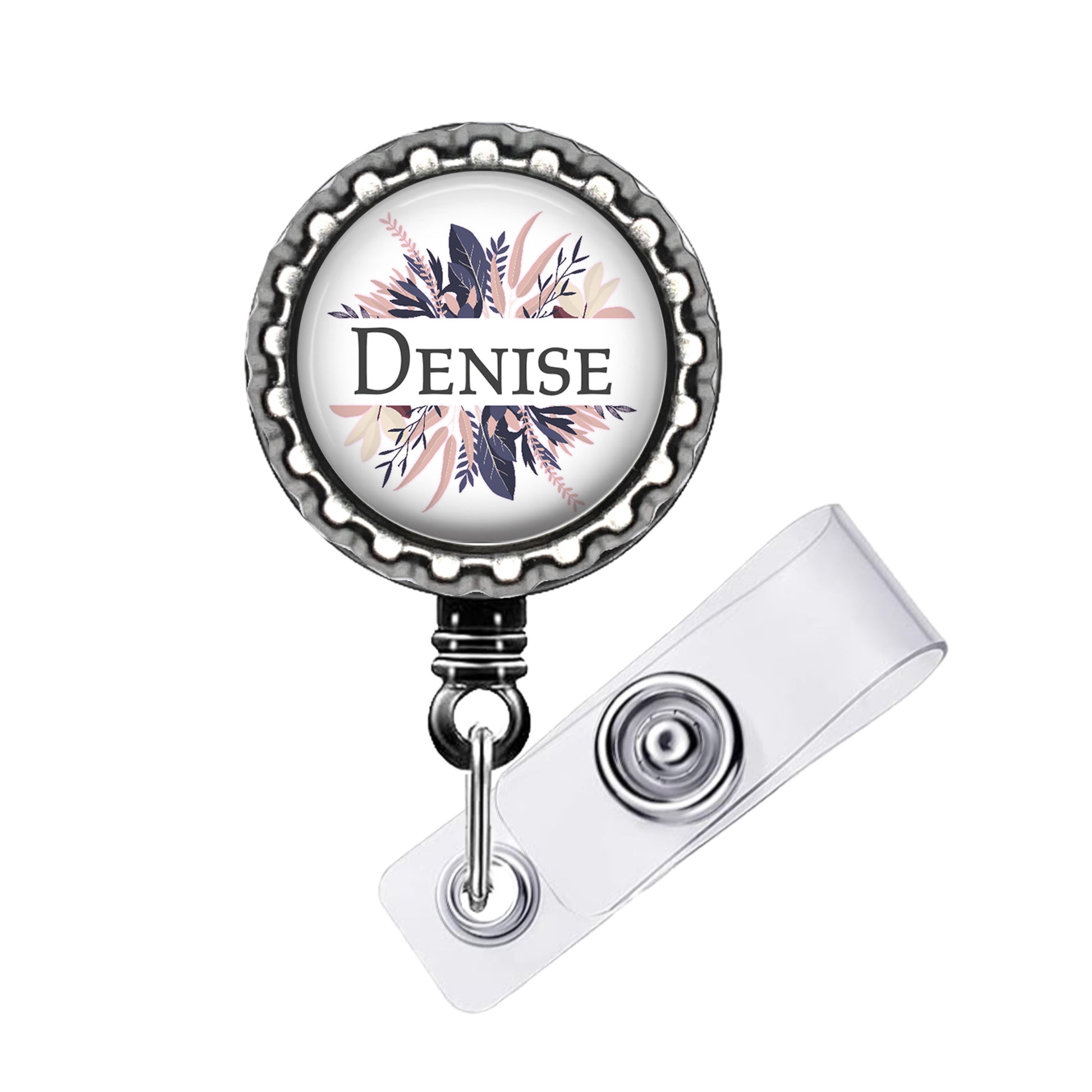 A badge holder with a decorative floral design and the name "Denise" printed on it.