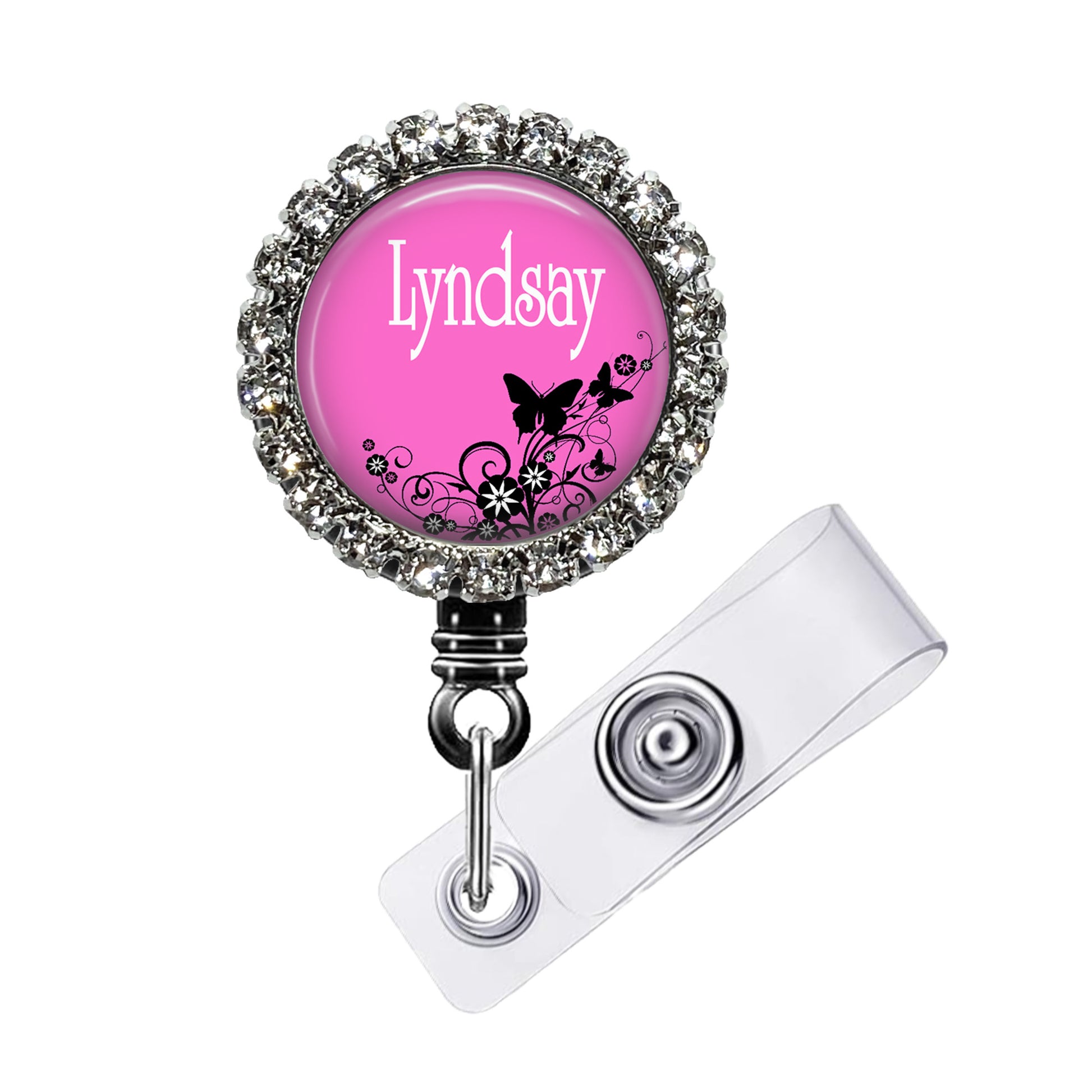 A pink badge with a name tag attached to it.