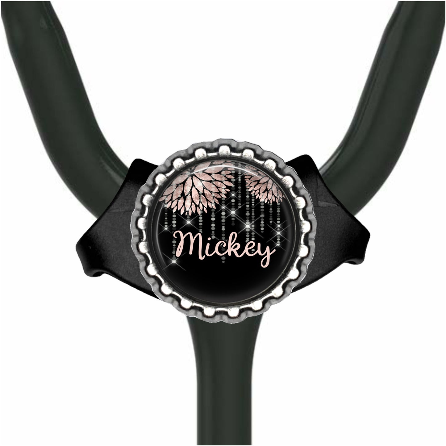 A black stethoscope with a round, black and silver badge featuring the name "Mickey" and a floral design.