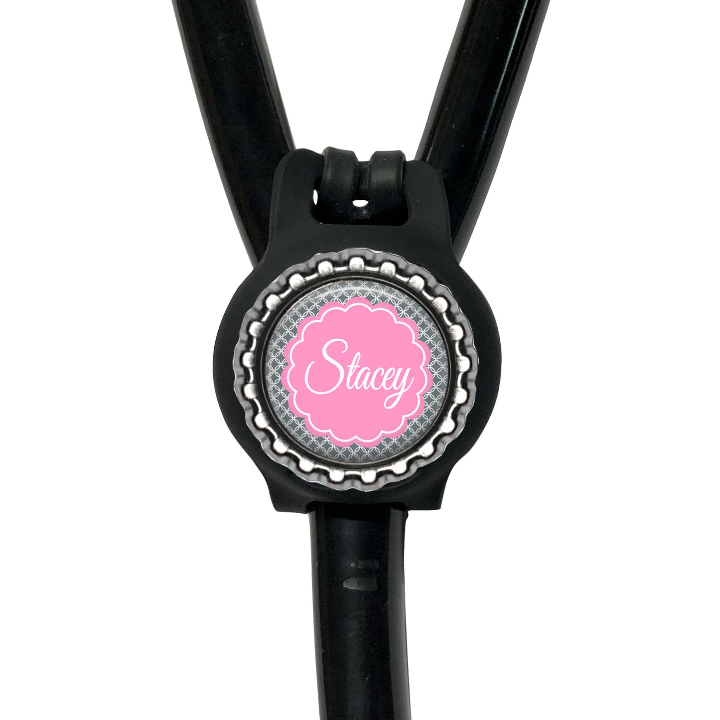 A black stethoscope with a personalized name badge attached to it.