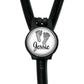 A black stethoscope with a round badge featuring a pair of baby feet and the name " Jessie" written on it.
