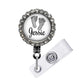 A personalized name badge with a rhinestone-encrusted frame, featuring a small image of a baby's feet and the name " Jessie" written on the frame.