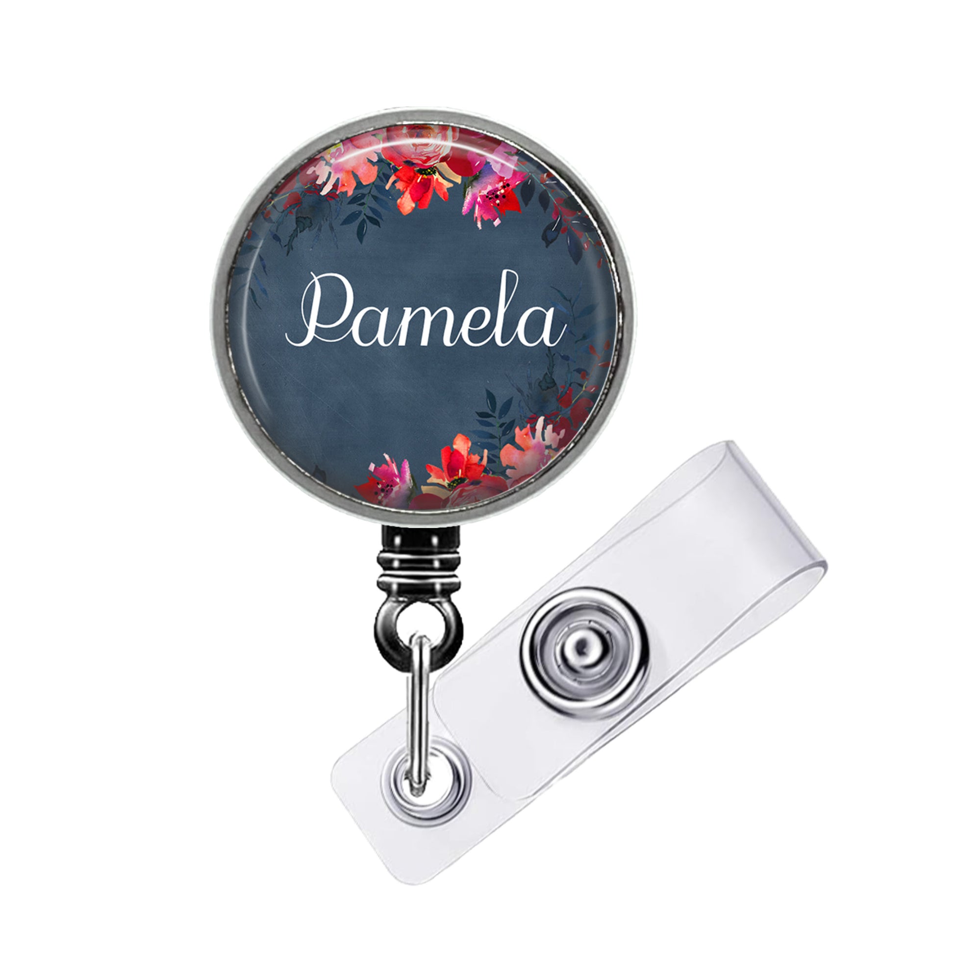 A round badge holder with a floral design and the name "Pamela" printed on it.