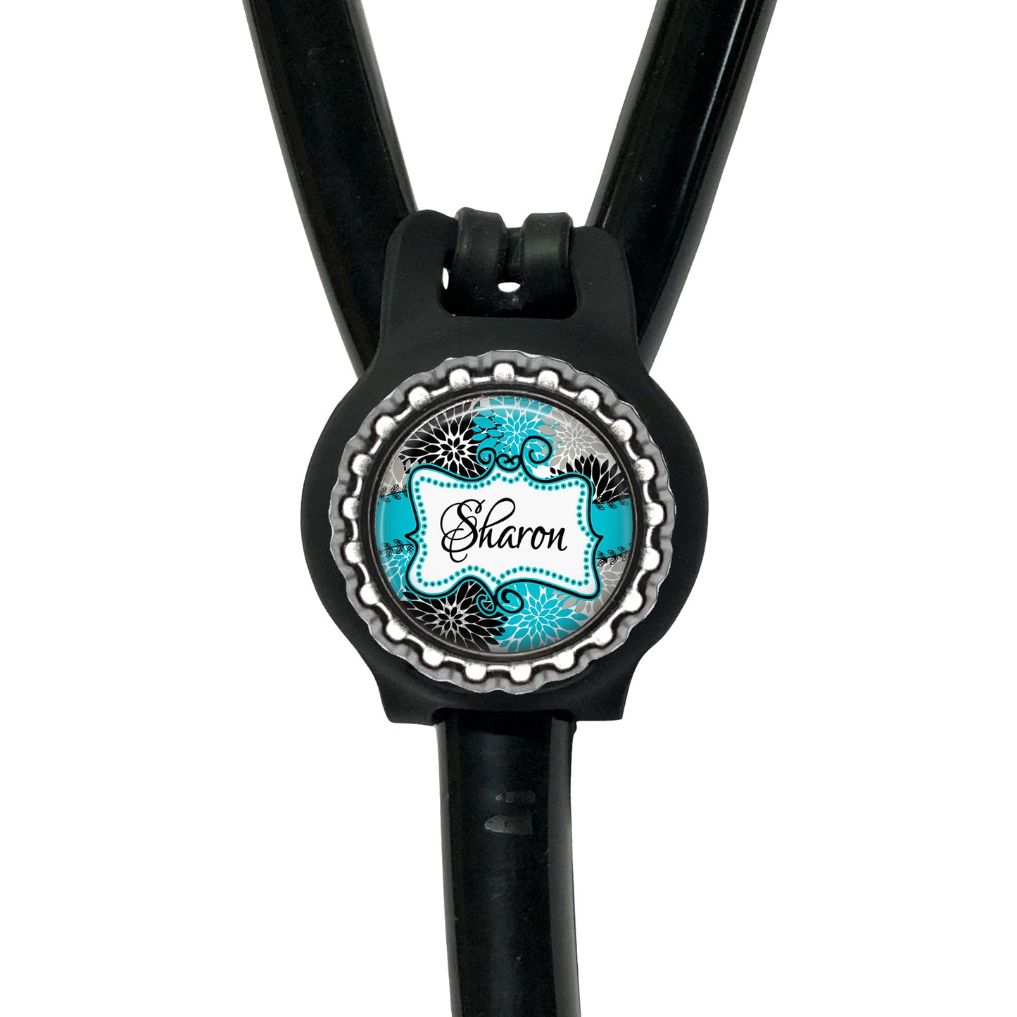 A black stethoscope with a personalized name badge attached to it.