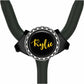 A black stethoscope with a personalized name badge attached to it.