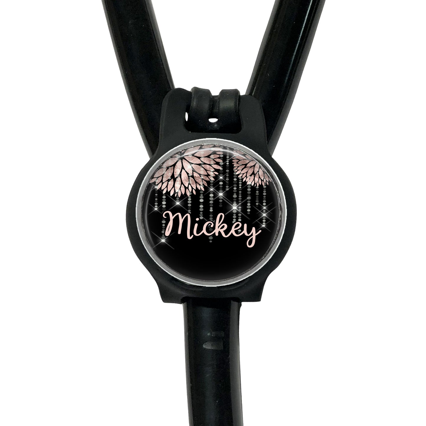 A black stethoscope with a personalized name badge attached to it.