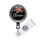 A black and silver badge holder with a floral design and the name "Shannon" written on it.