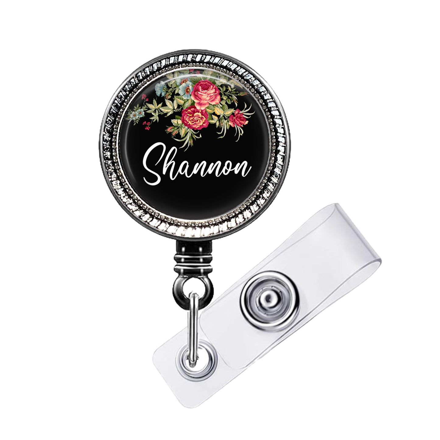 A black and silver badge holder with a floral design and the name "Shannon" written on it.