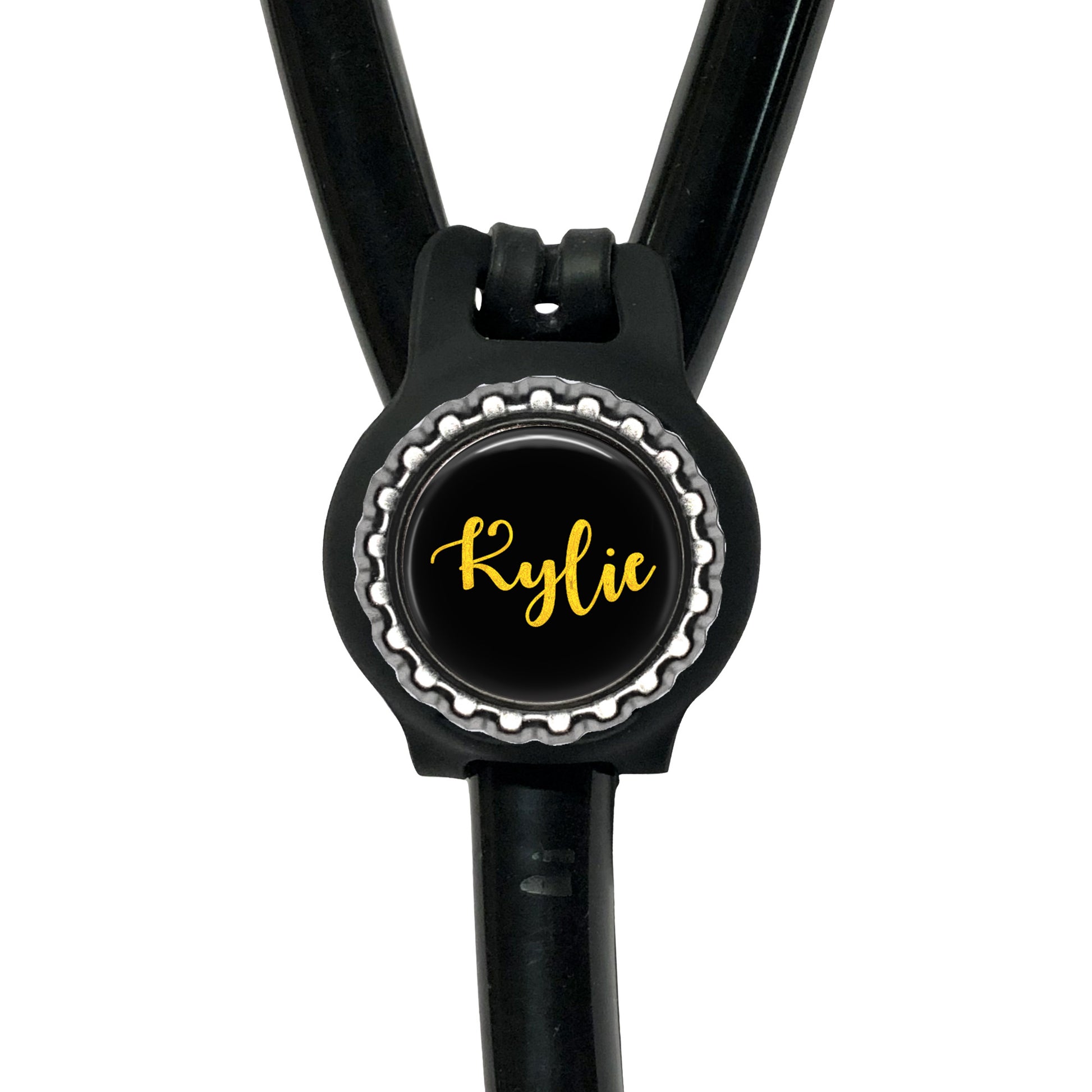 A black stethoscope with a personalized name badge attached to it.