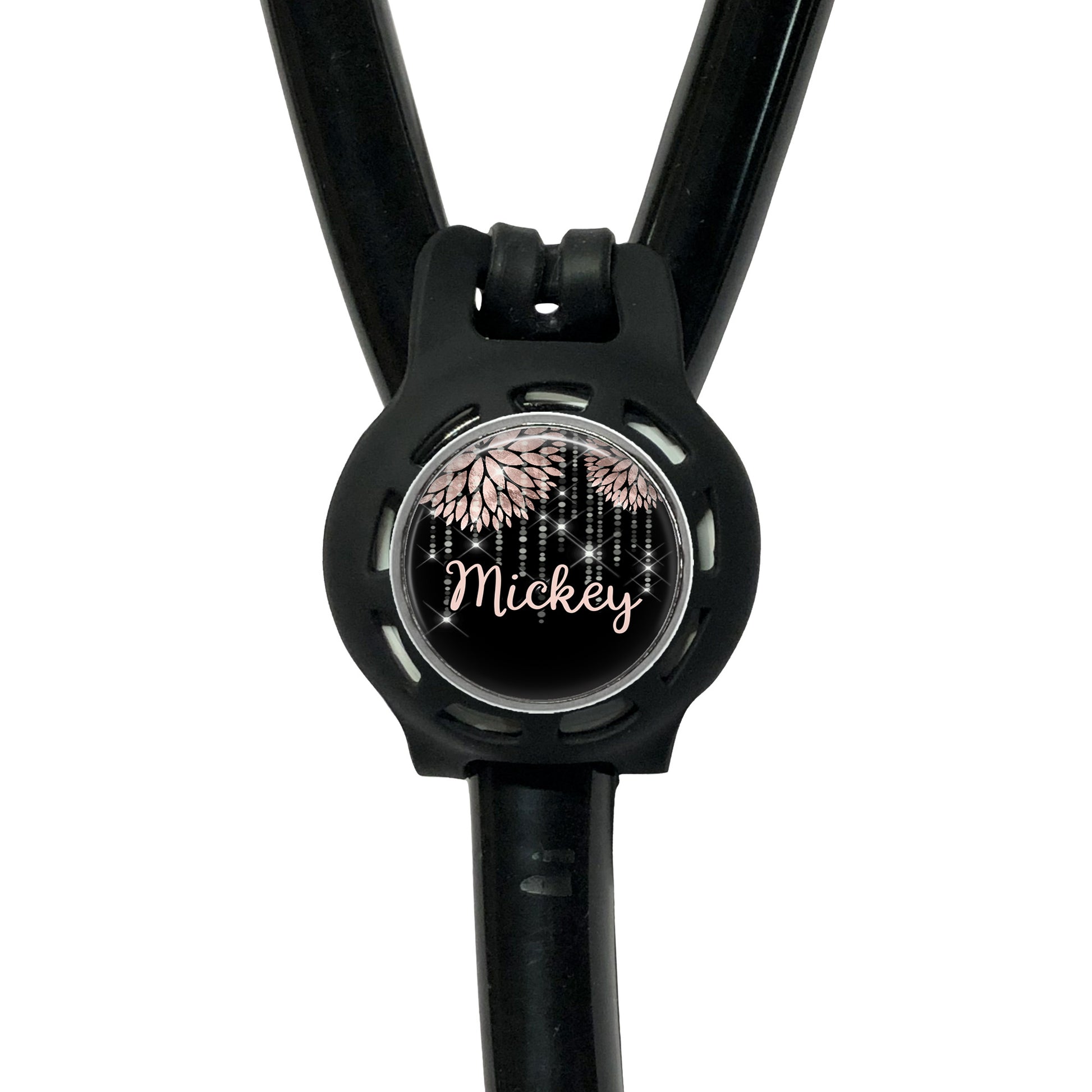 A black stethoscope with a round, personalized name tag attached to it.