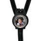 A black stethoscope with a circular frame containing a photo of a smiling person.