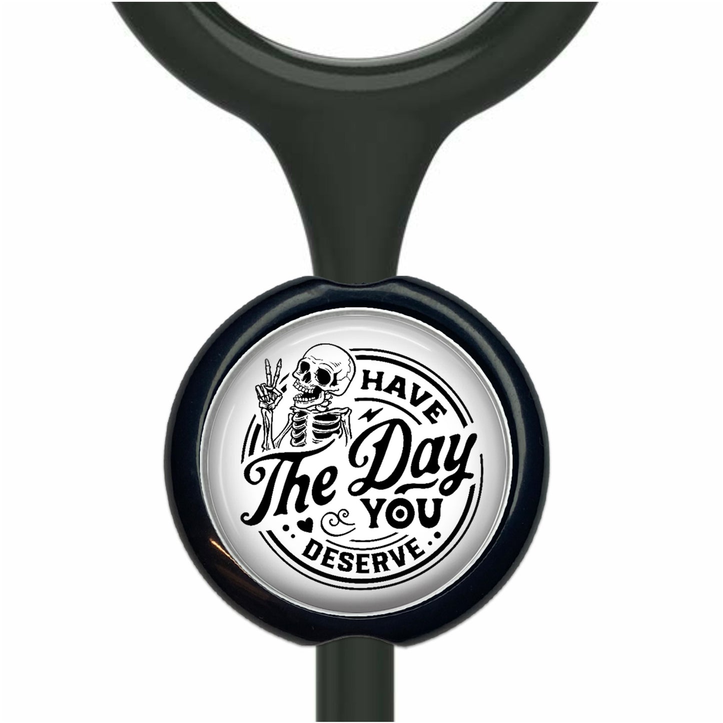 A black and white sticker with a skeleton holding a peace sign and the text "The Day You Deserve" printed on it.