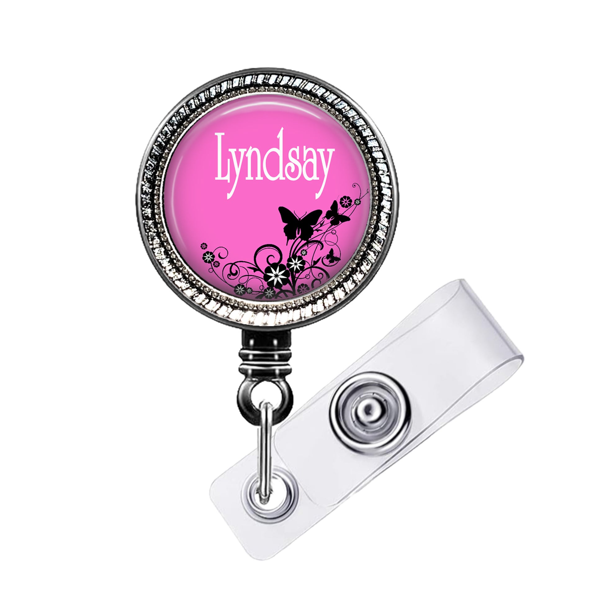 A pink badge holder with the name "Lyndsay" written on it, featuring a floral design.