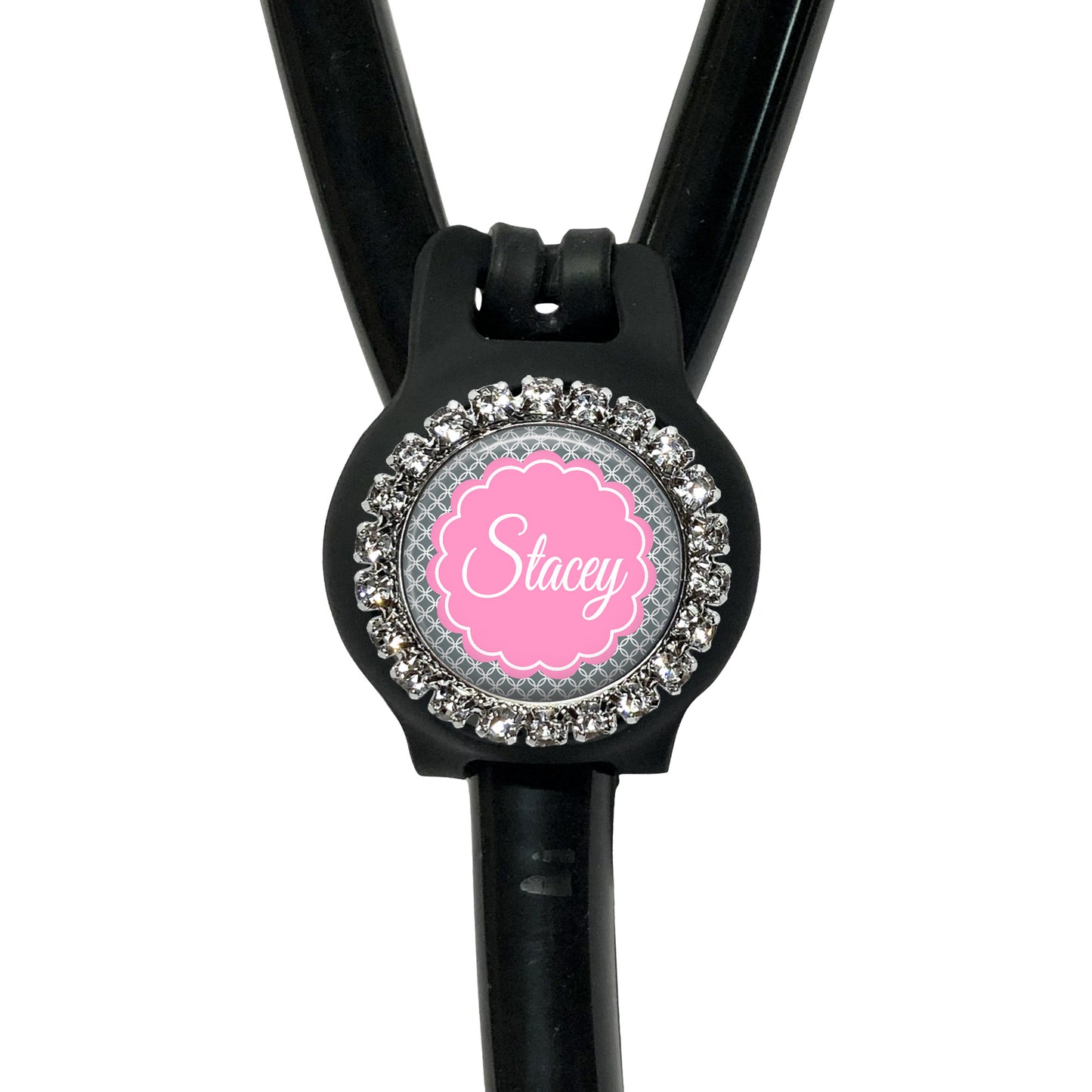 A black stethoscope with a personalized name tag attached to it.