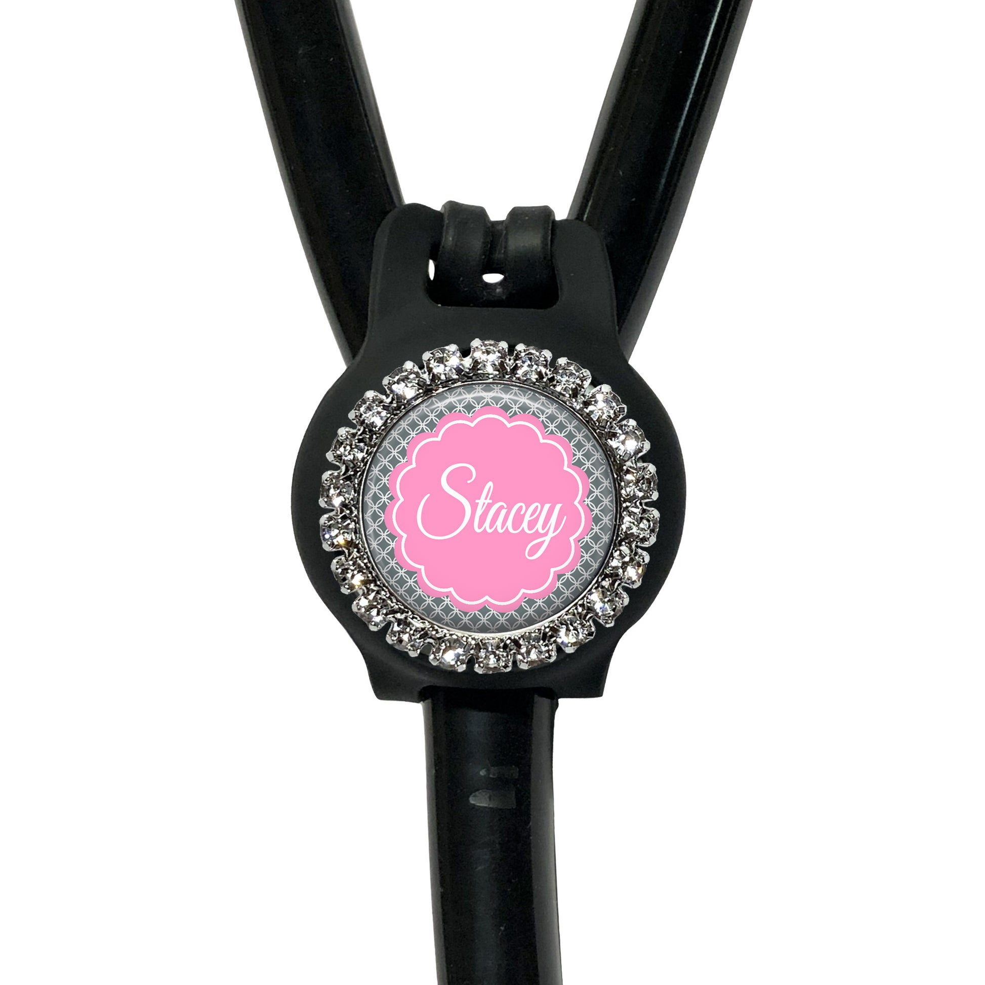 A black stethoscope with a personalized name tag attached to it.