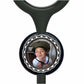 A young boy wearing a hat is smiling at the camera, with a black stethoscope charm featuring a circular photo of the boy attached to it.