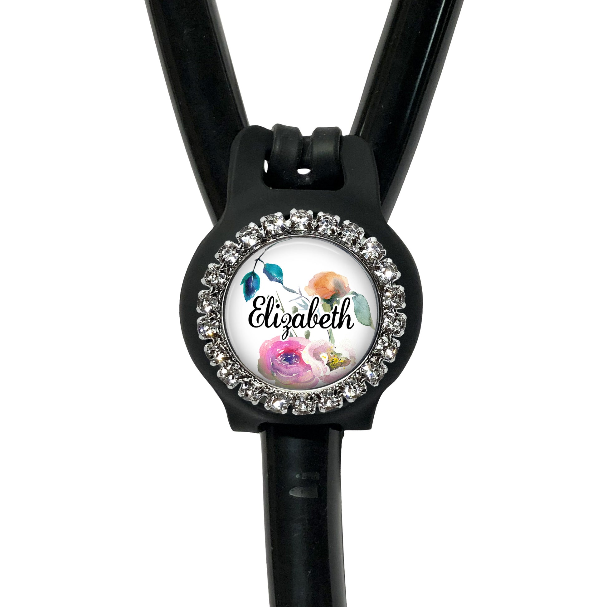 A black stethoscope with a personalized name badge attached to it.