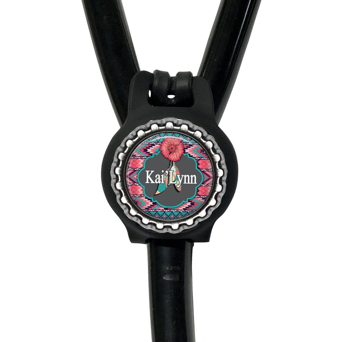 A black stethoscope with a personalized name badge attached to it.