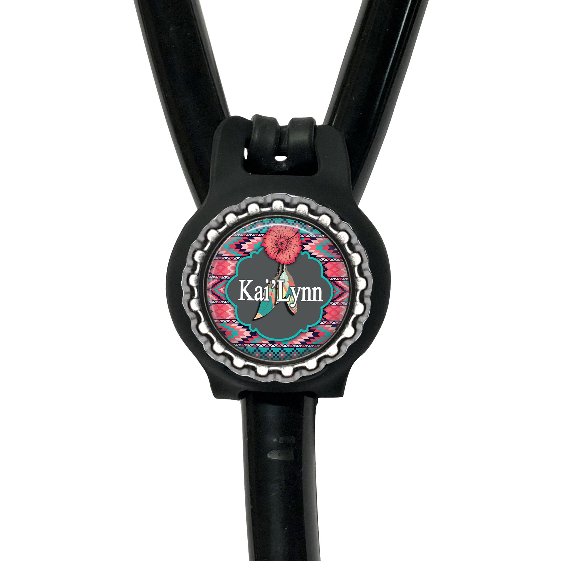 A black stethoscope with a personalized name badge attached to it.
