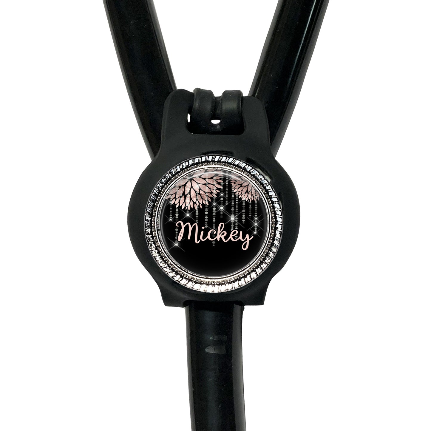 A black stethoscope with a round, personalized name tag attached to it.