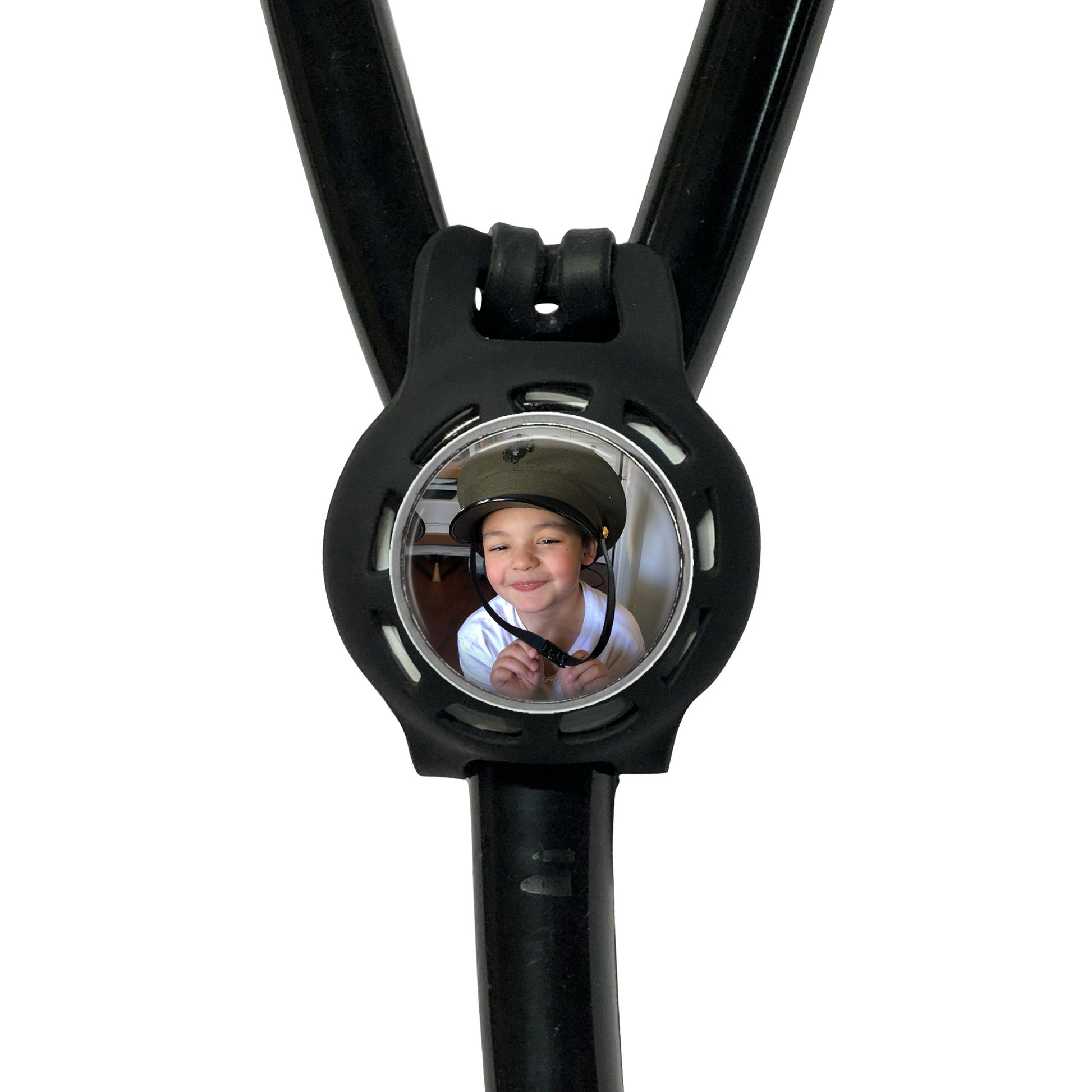 A black stethoscope with a circular mirror attached to it, displaying a smiling young boy wearing a helmet.