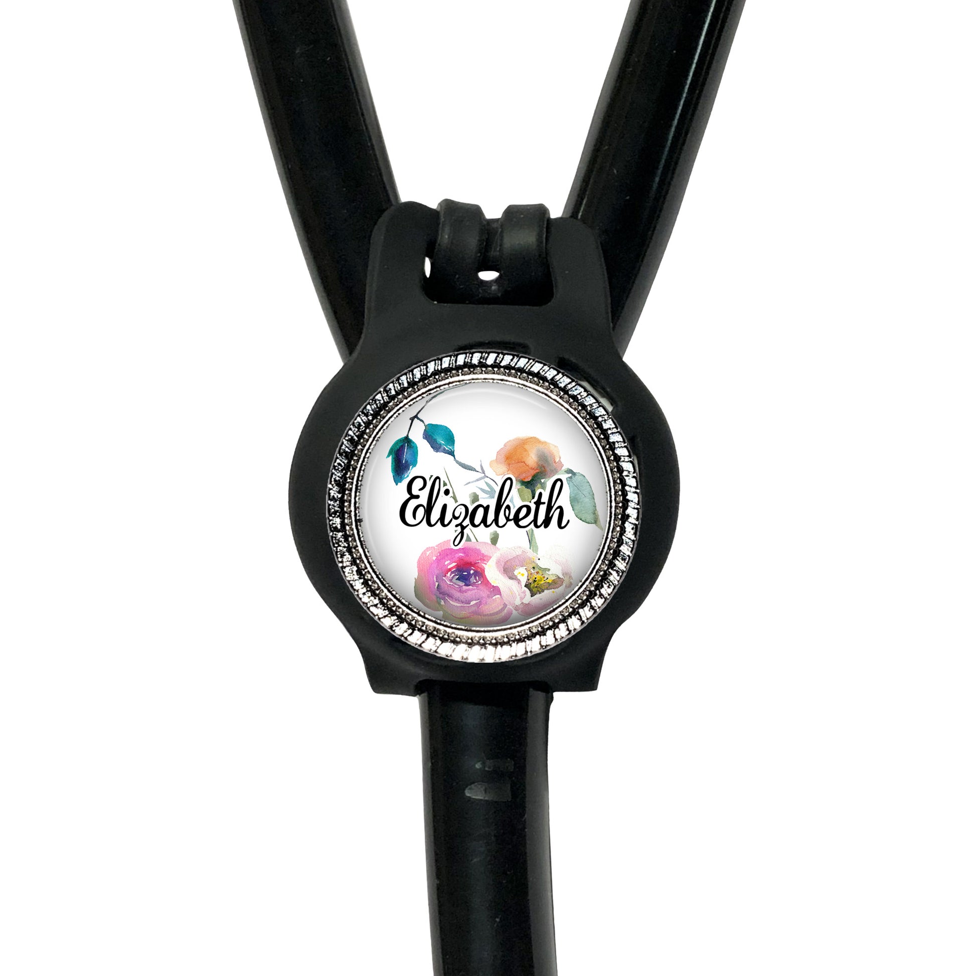 A black stethoscope with a personalized name badge attached to it.