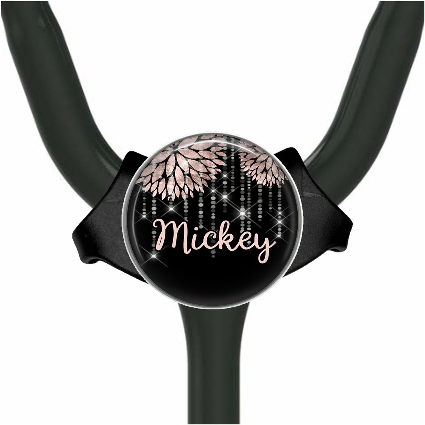 A black stethoscope with a personalized name badge attached to it.