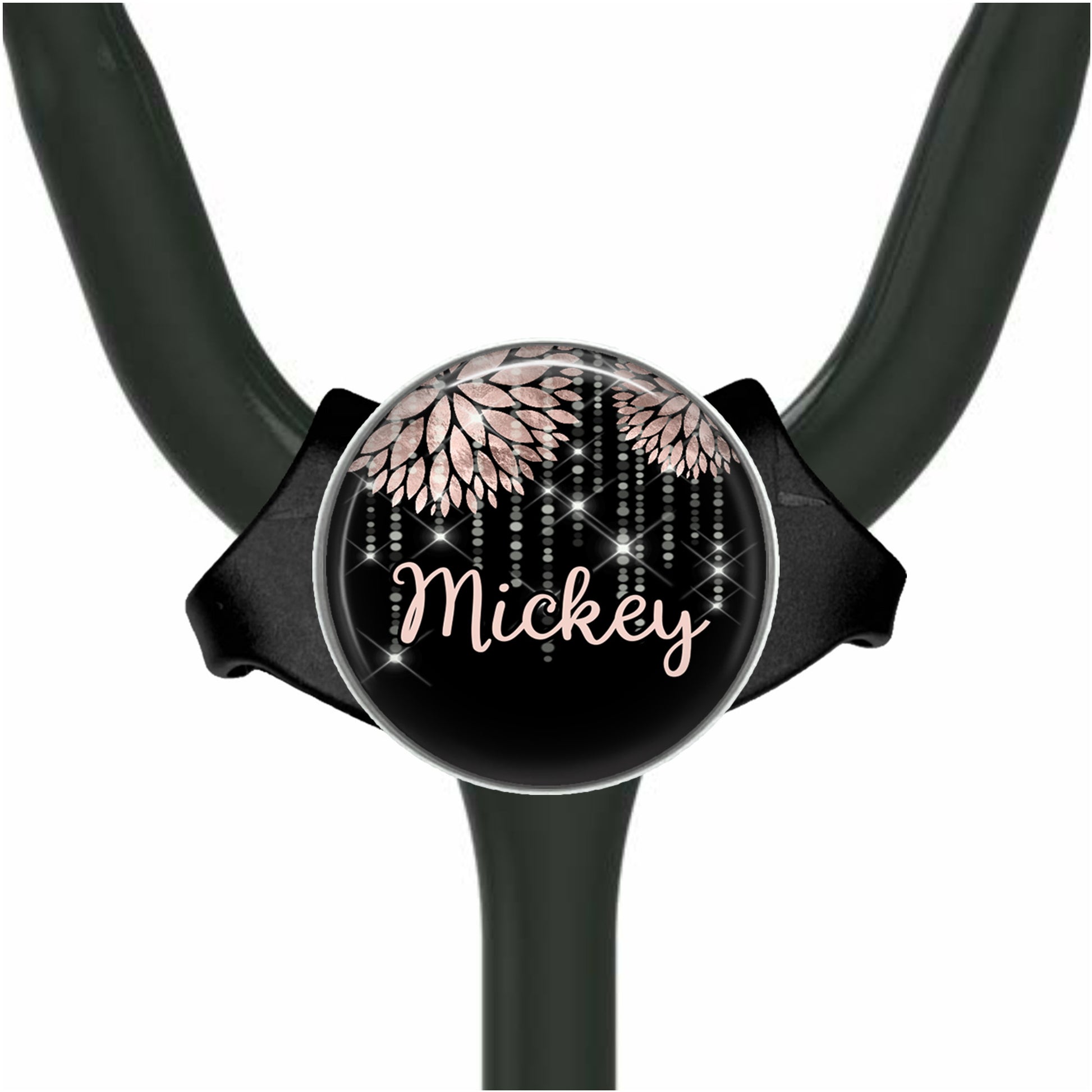 A black stethoscope with a personalized name badge attached to it.