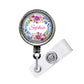 A round badge holder with a floral design and the name "Sophia" printed on it.