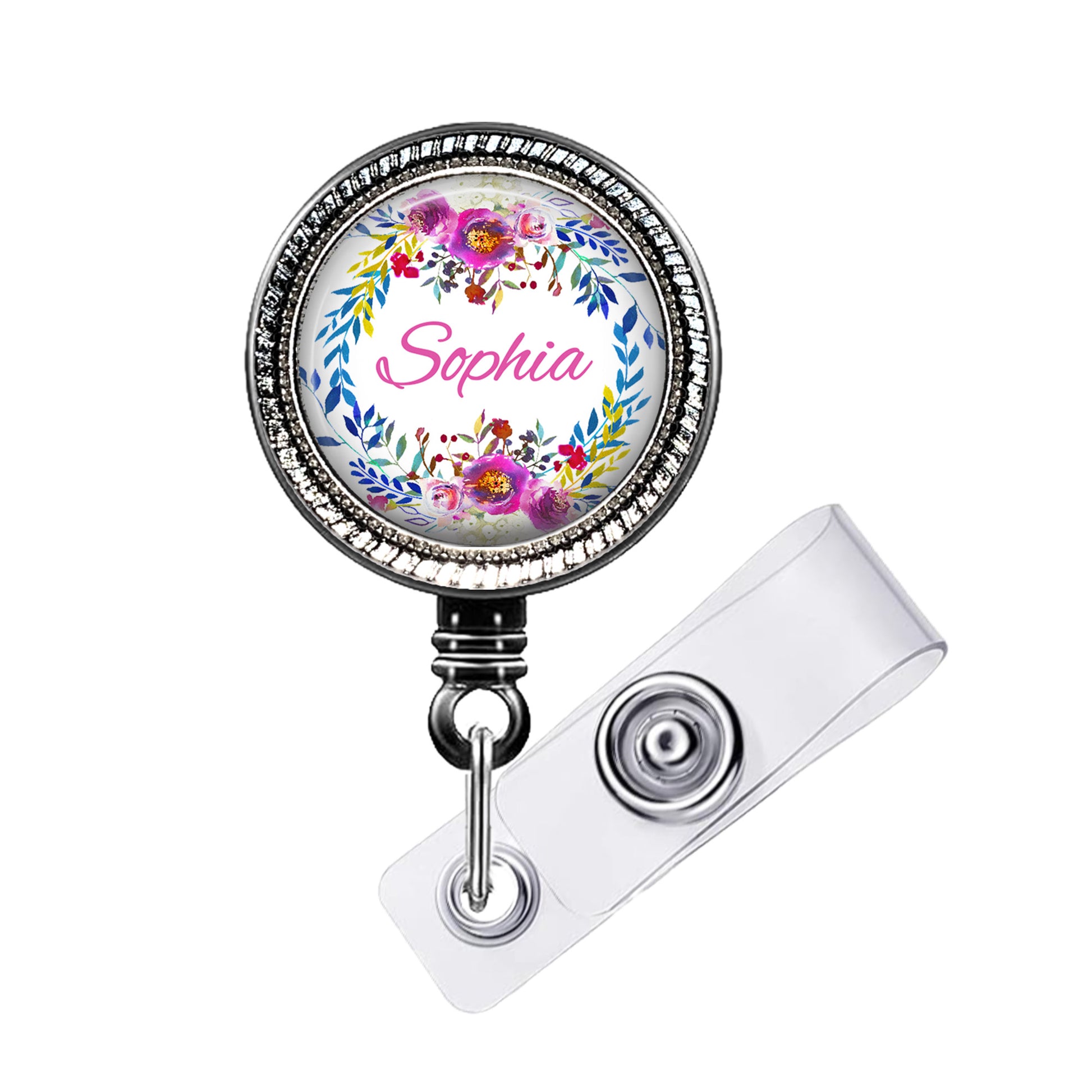 A round badge holder with a floral design and the name "Sophia" printed on it.