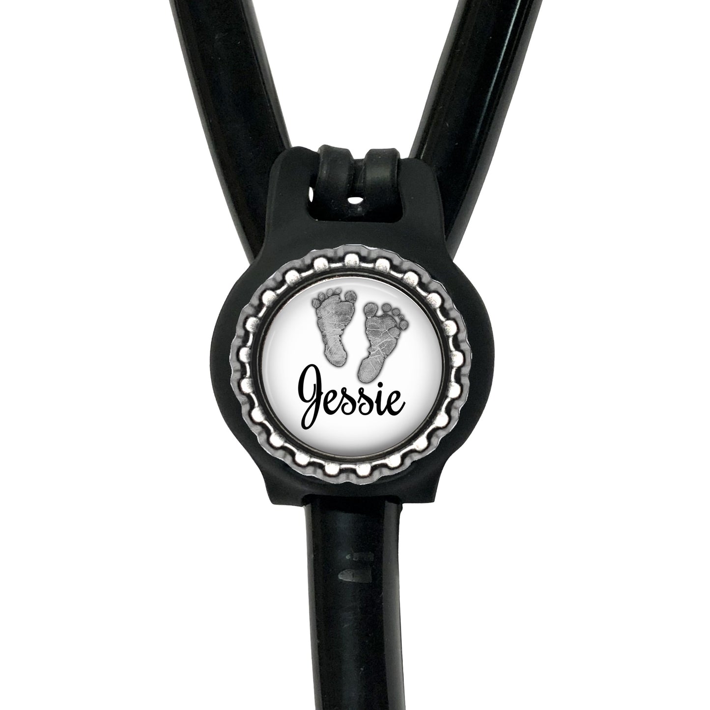A black stethoscope with a personalized name badge attached to it.