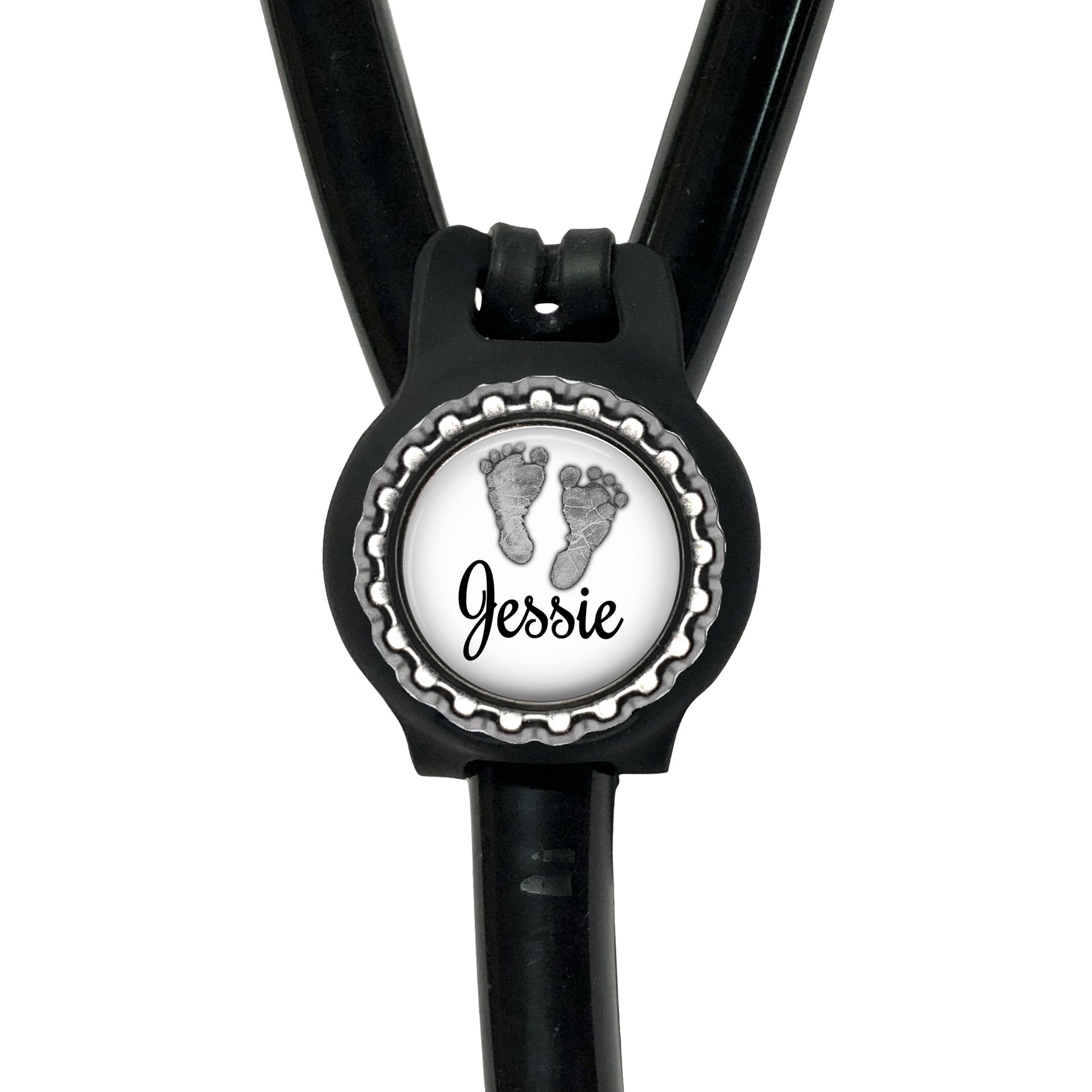 A black stethoscope with a personalized name badge attached to it.